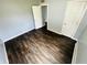 Bright bedroom with dark hardwood floors and a closet at 128 E 36Th St, Anderson, IN 46013