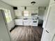 Bright kitchen featuring white cabinets, an updated countertop, and modern appliances at 128 E 36Th St, Anderson, IN 46013