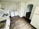 Functional kitchen with white cabinets, modern appliances and a connected washer and dryer at 128 E 36Th St, Anderson, IN 46013
