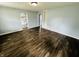 Inviting living room with dark hardwood floors and an open doorway to the kitchen at 128 E 36Th St, Anderson, IN 46013