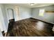 Clean living room with fresh paint, faux wood flooring, and built-in shelving at 128 E 36Th St, Anderson, IN 46013