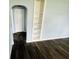 Living room with dark hardwood floors, built-in shelving, and an arched doorway to another room at 128 E 36Th St, Anderson, IN 46013