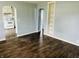 Inviting living room with dark hardwood floors and an open doorway to the kitchen at 128 E 36Th St, Anderson, IN 46013