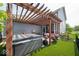 Beautiful backyard with a hot tub, pergola covered patio, and well-manicured lawn at 12976 Walbeck Dr, Fishers, IN 46037