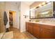 Elegant bathroom with double sinks, spacious vanity, and a view into a walk-in closet at 12976 Walbeck Dr, Fishers, IN 46037