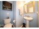 Powder room featuring a pedestal sink and wooden vanity at 12976 Walbeck Dr, Fishers, IN 46037