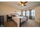 Comfortable bedroom with plush carpet, ceiling fan, and light-filled windows with stylish shutters at 12976 Walbeck Dr, Fishers, IN 46037
