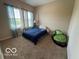 Bedroom with blue comforter, curtains, and neutral carpet at 12976 Walbeck Dr, Fishers, IN 46037