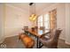 Well-lit dining room featuring a large wooden table, bench seating, and elegant window shutters at 12976 Walbeck Dr, Fishers, IN 46037