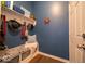 Cozy entryway featuring blue walls, a convenient bench with storage, and a shelf for hats and accessories at 12976 Walbeck Dr, Fishers, IN 46037