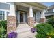 Close-up of the covered front porch with stone columns and a welcoming entrance at 12976 Walbeck Dr, Fishers, IN 46037