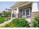Covered front porch featuring stone columns, a seating area, and a well-manicured lawn at 12976 Walbeck Dr, Fishers, IN 46037