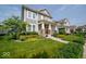 Inviting front yard featuring a lush green lawn, colorful flower beds, and a charming two-story home at 12976 Walbeck Dr, Fishers, IN 46037