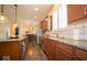 Kitchen featuring stone countertops, wooden cabinets, and stainless appliances at 12976 Walbeck Dr, Fishers, IN 46037