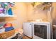 Functional laundry room equipped with modern washer, dryer, and ample shelving for supplies at 12976 Walbeck Dr, Fishers, IN 46037