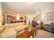 Open-concept living room showcasing the kitchen and staircase at 12976 Walbeck Dr, Fishers, IN 46037