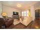 Open-concept living area with hardwood floors and large windows at 12976 Walbeck Dr, Fishers, IN 46037