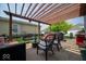Relaxing patio area with comfortable seating, a grill, and a pergola for shade at 12976 Walbeck Dr, Fishers, IN 46037