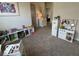 Bright playroom with toy kitchen, storage shelves, and neutral carpet at 12976 Walbeck Dr, Fishers, IN 46037
