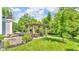 Landscaped backyard featuring a pergola with dining area and outdoor grill, perfect for summer gatherings and outdoor dining at 13304 Landwood Dr, Fishers, IN 46037