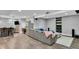 A modern basement living area features stainless steel appliances, a large couch, and bar seating at 13304 Landwood Dr, Fishers, IN 46037