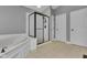 Well-lit bathroom with a shower, soaking tub, and neutral colored tile floor at 13304 Landwood Dr, Fishers, IN 46037