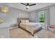 Cozy bedroom with gray walls, neutral toned decor, ceiling fan and a sunlit window at 13304 Landwood Dr, Fishers, IN 46037