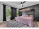 This stylish bedroom features a bunk bed, large windows with dark curtains, and gray accent wall at 13304 Landwood Dr, Fishers, IN 46037