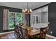Dining room with dark accent wall, large window, and decorative chandelier at 13304 Landwood Dr, Fishers, IN 46037