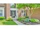 Home entrance featuring stylish black door, sidelights, transom, and curated front yard landscaping at 13304 Landwood Dr, Fishers, IN 46037
