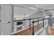 Second story foyer with hardwood floors and railing overlooking the living room below at 13304 Landwood Dr, Fishers, IN 46037