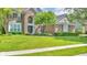 Beautiful brick home featuring a well-manicured lawn, lush landscaping, and inviting facade at 13304 Landwood Dr, Fishers, IN 46037