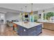 Stunning kitchen with large island, quartz countertops, and gold pendant lighting, perfect for entertaining and modern living at 13304 Landwood Dr, Fishers, IN 46037