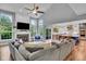 Bright living room with fireplace, vaulted ceilings, and open layout connecting to a modern kitchen at 13304 Landwood Dr, Fishers, IN 46037