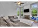 Spacious living room with large windows, a fireplace, and comfortable seating, creating a welcoming atmosphere at 13304 Landwood Dr, Fishers, IN 46037