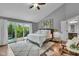 Bright bedroom featuring a balcony, hardwood floors, and stylish decor at 13304 Landwood Dr, Fishers, IN 46037
