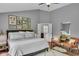 Stylish bedroom with wood floor, sitting area, framed photos, and en-suite bathroom with tub at 13304 Landwood Dr, Fishers, IN 46037