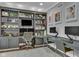 Home office showcasing dual desks, built-in shelving, and abundant natural light at 13304 Landwood Dr, Fishers, IN 46037