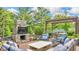 Outdoor patio featuring a stone fireplace, pergola, and cozy seating arrangement at 13304 Landwood Dr, Fishers, IN 46037