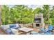 Inviting outdoor living space with stone fireplace, TV, and comfortable seating at 13304 Landwood Dr, Fishers, IN 46037