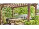 Charming outdoor patio featuring a wooden pergola and dining table at 13304 Landwood Dr, Fishers, IN 46037