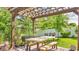 Backyard pergola with picnic table and outdoor seating, providing a relaxing spot to enjoy the beautifully landscaped yard at 13304 Landwood Dr, Fishers, IN 46037
