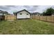 View of the backyard featuring a new privacy fence and an exterior view of the home at 1429 Udell St, Indianapolis, IN 46208
