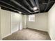 Finished basement room boasts neutral walls, a window, and neutral carpet flooring at 1429 Udell St, Indianapolis, IN 46208