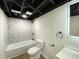 Renovated bathroom features modern vanity, with an illuminated mirror and a tiled shower at 1429 Udell St, Indianapolis, IN 46208