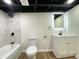 Renovated bathroom features tiled shower, modern fixtures, and a bright vanity with an illuminated mirror at 1429 Udell St, Indianapolis, IN 46208