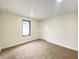 Bright bedroom features neutral walls, a window, and plush carpet, offering a cozy and inviting space at 1429 Udell St, Indianapolis, IN 46208