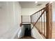 Staircase featuring wood railings and treads leads to a lower level with dark-painted floors at 1429 Udell St, Indianapolis, IN 46208