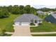 Charming single-Gathering home with a three-car garage, a well-manicured lawn, and beautiful landscaping at 1497 Maple Ridge Ct, Columbus, IN 47201