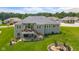 Aerial view of home exterior featuring a tiered deck, fire pit, and manicured lawn at 1497 Maple Ridge Ct, Columbus, IN 47201
